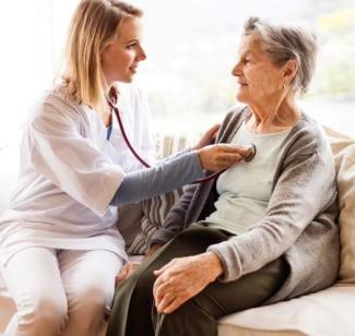 Older woman with visiting nurse, stethoscope