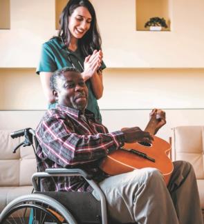 man in wheelchair with guitar