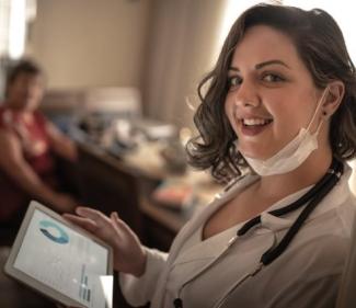 nurse in doorway with laptop