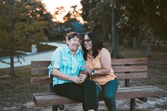 Two people sitting on a park bench